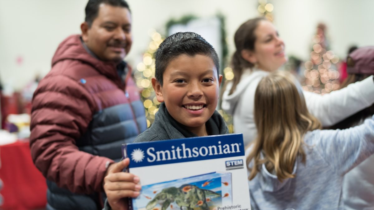 Kid holding up a Smithsonian toy
